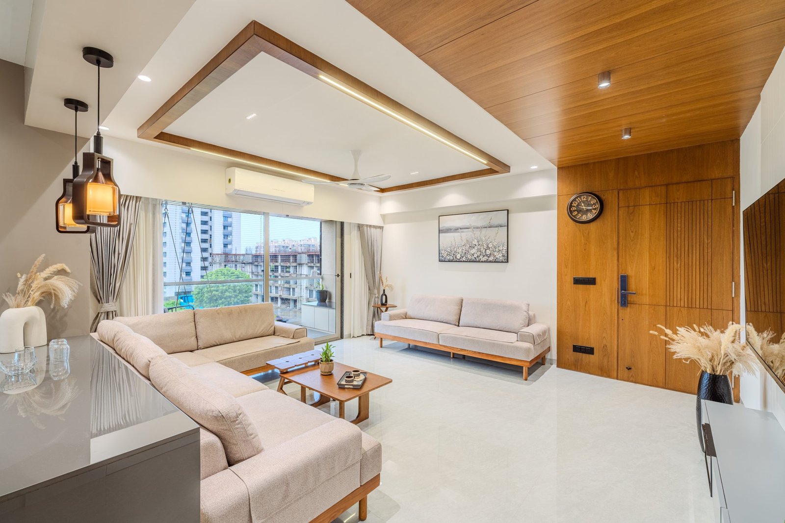Living room with timber ceiling and entrance, Jayendra Bhai Residence by Himanshu Raval Architects